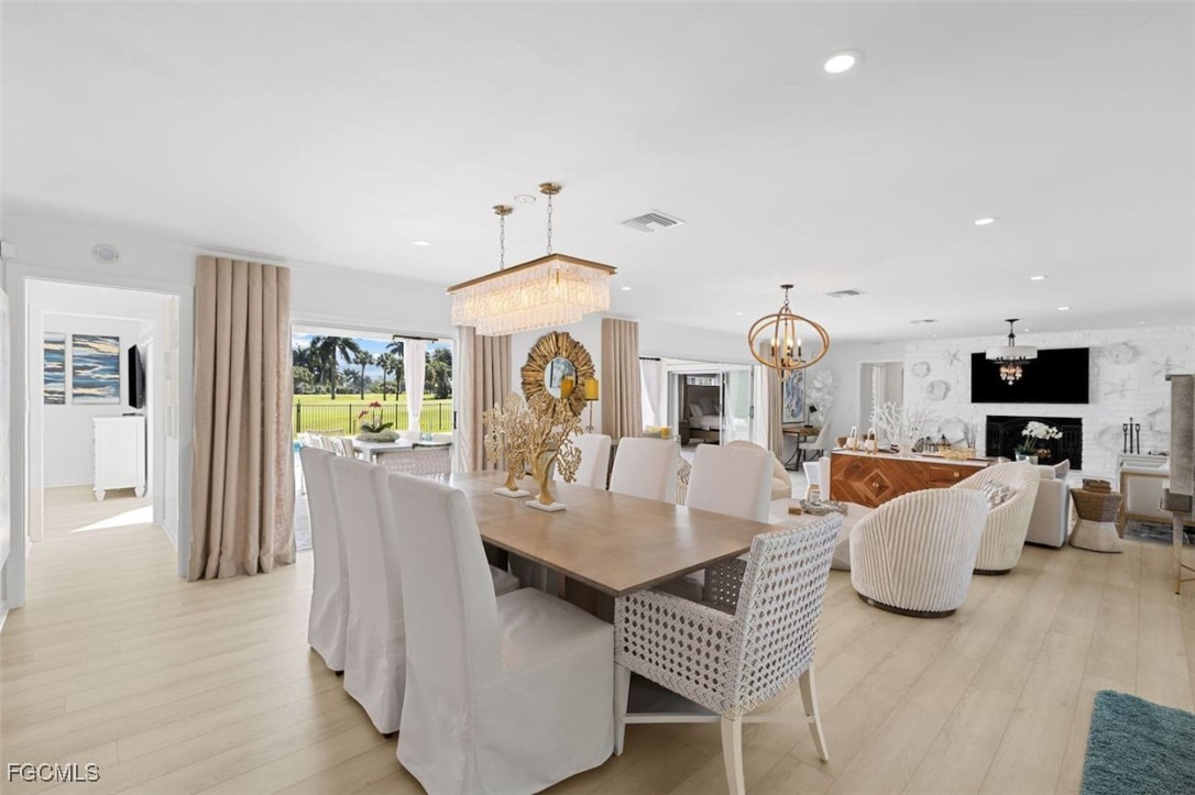 2728 Crayton Road Naples, FL 34103 - Photo 7 of 35 a living room with furniture a flat screen tv and a table