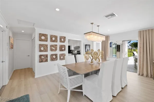 a dining room with furniture and wooden floor