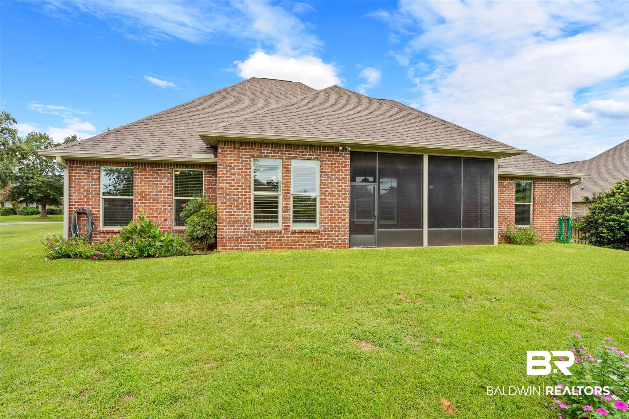 423 Breckin Drive Fairhope, AL 36532 - Photo 2 of 31 Rear view of house featuring a lawn and a sunroom