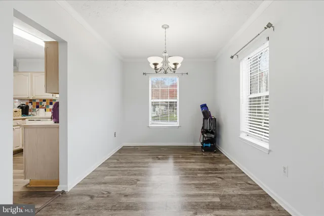 a view of a livingroom with wooden floor and a fireplace