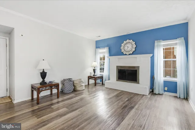 a view of a room with wooden floor and furniture