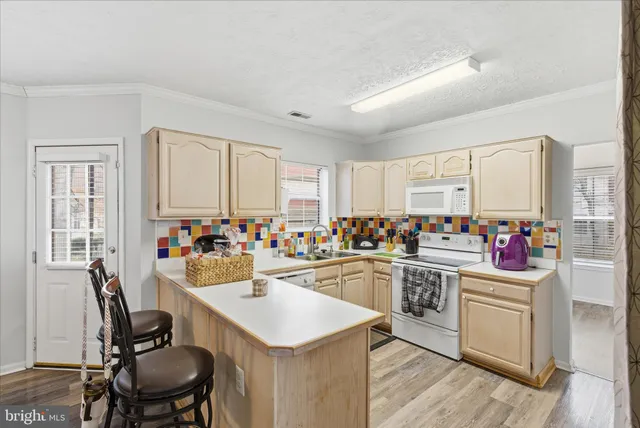 a kitchen with sink a stove and cabinets