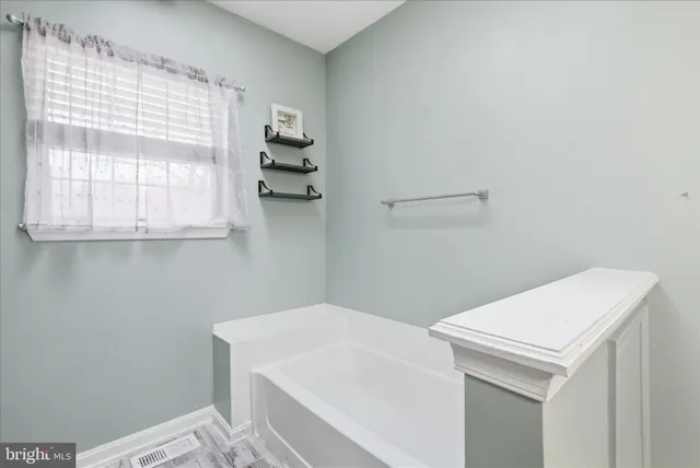 a bathroom with a toilet a sink and a window