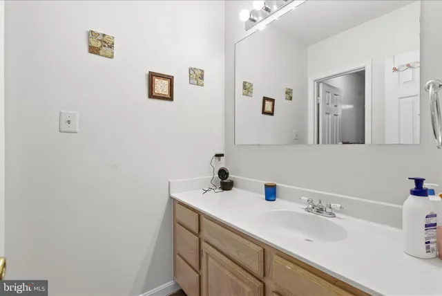a bathroom with a sink mirror and vanity