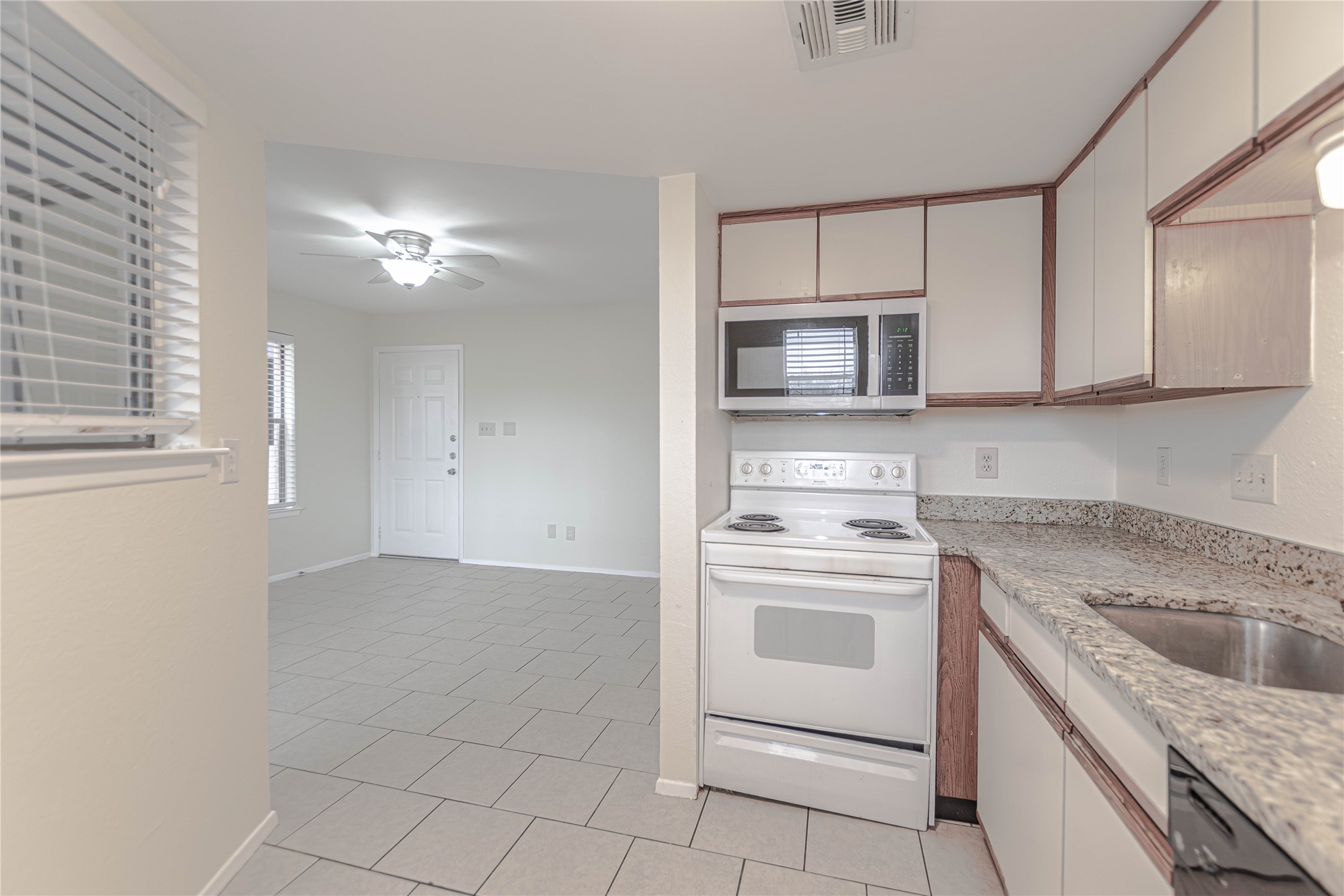 2500 Burleson Road, Unit 601 Austin, TX 78741 - Photo 6 of 20 a kitchen with cabinets stainless steel appliances and a window