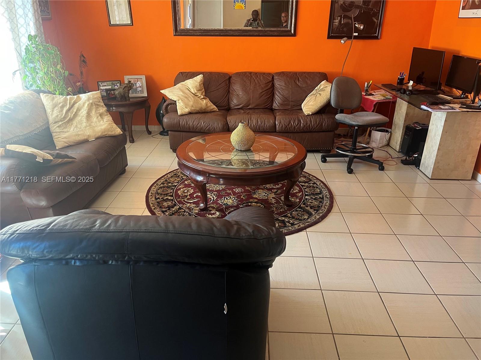 11041 Southwest 166th Terrace Miami, FL 33157 - Photo 13 of 33 a living room with furniture a rug and a lamp