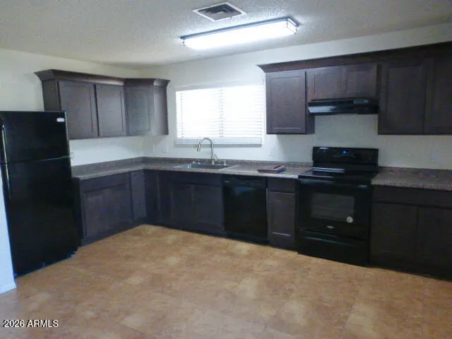 a kitchen with a sink and a stove