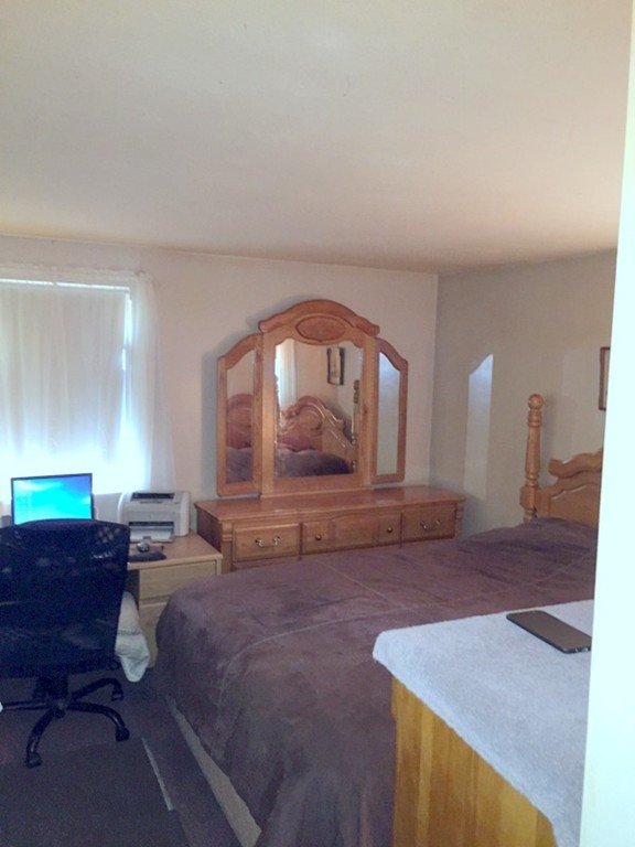 48 East Allen Ridge Road Springfield, MA 01118 - Photo 9 of 25 a living room with furniture a large window and a fireplace