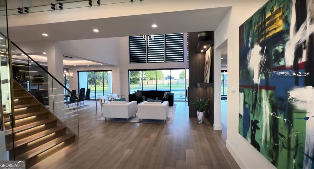 6711 Bishop Road Fairburn, GA 30213 - Photo 3 of 7 a living room with furniture and a wooden floor