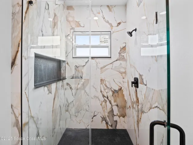 a bathroom with a double vanity sink toilet and shower