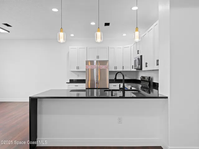 a view of kitchen with wooden floor