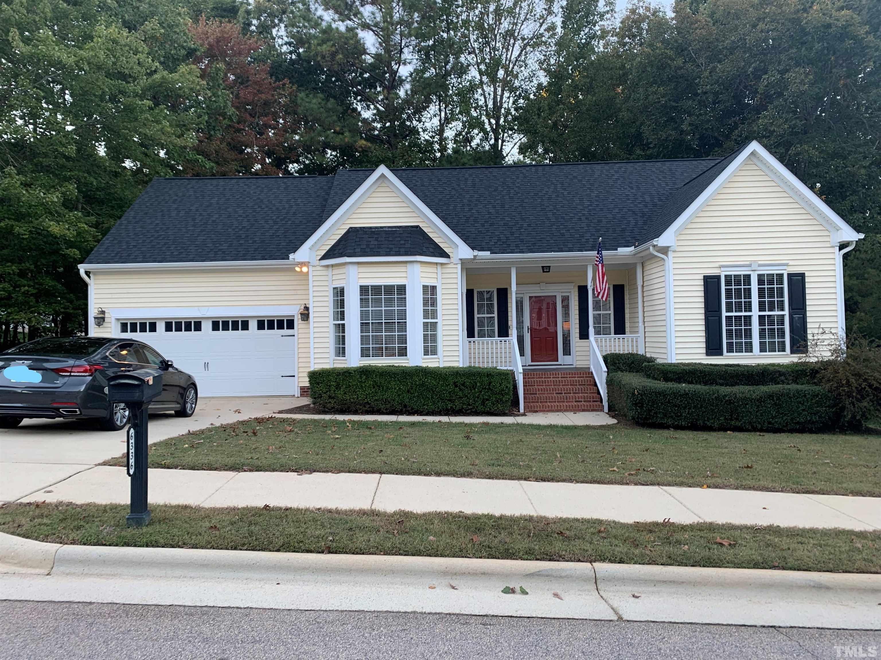 6336 Nowell Pointe Drive Raleigh, NC 27607 - Photo 3 of 25 a front view of a house with a yard and garage