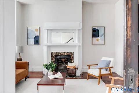 a living room with furniture and a fireplace