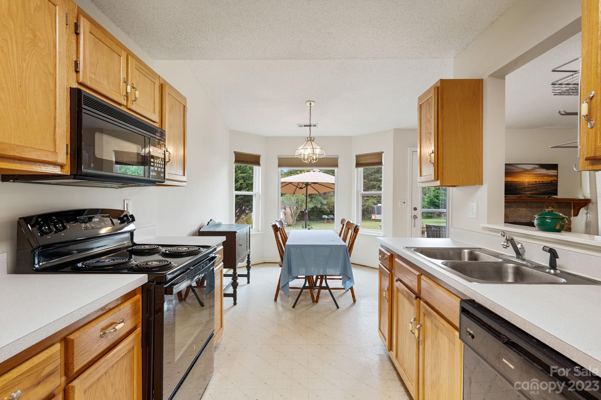 3691 Slanting Bridge Road Sherrills Ford, NC 28673 - Photo 11 of 33 a kitchen with a stove a sink a dining table and chairs