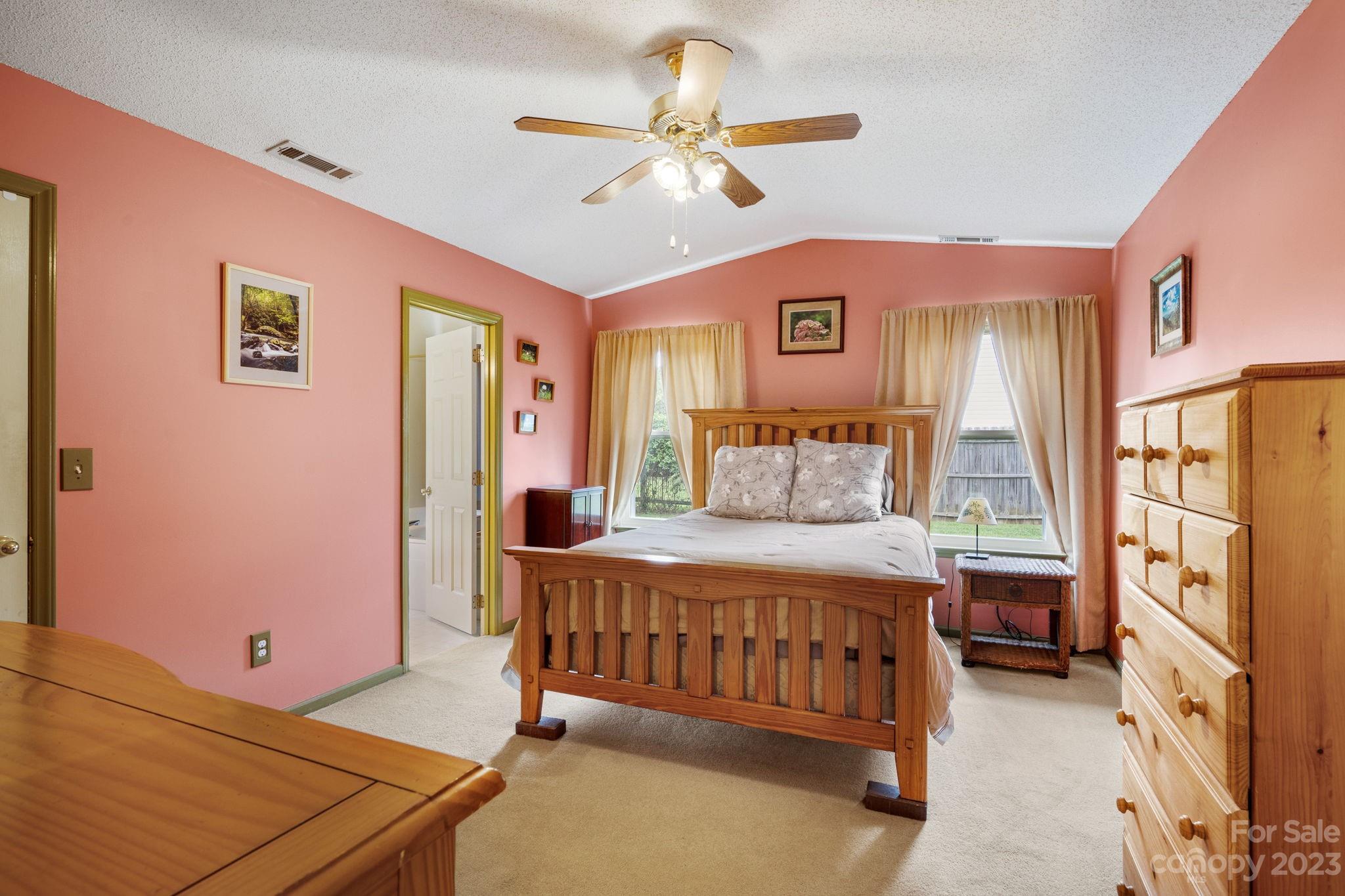 3691 Slanting Bridge Road Sherrills Ford, NC 28673 - Photo 12 of 33 a bedroom with a bed and a chandelier