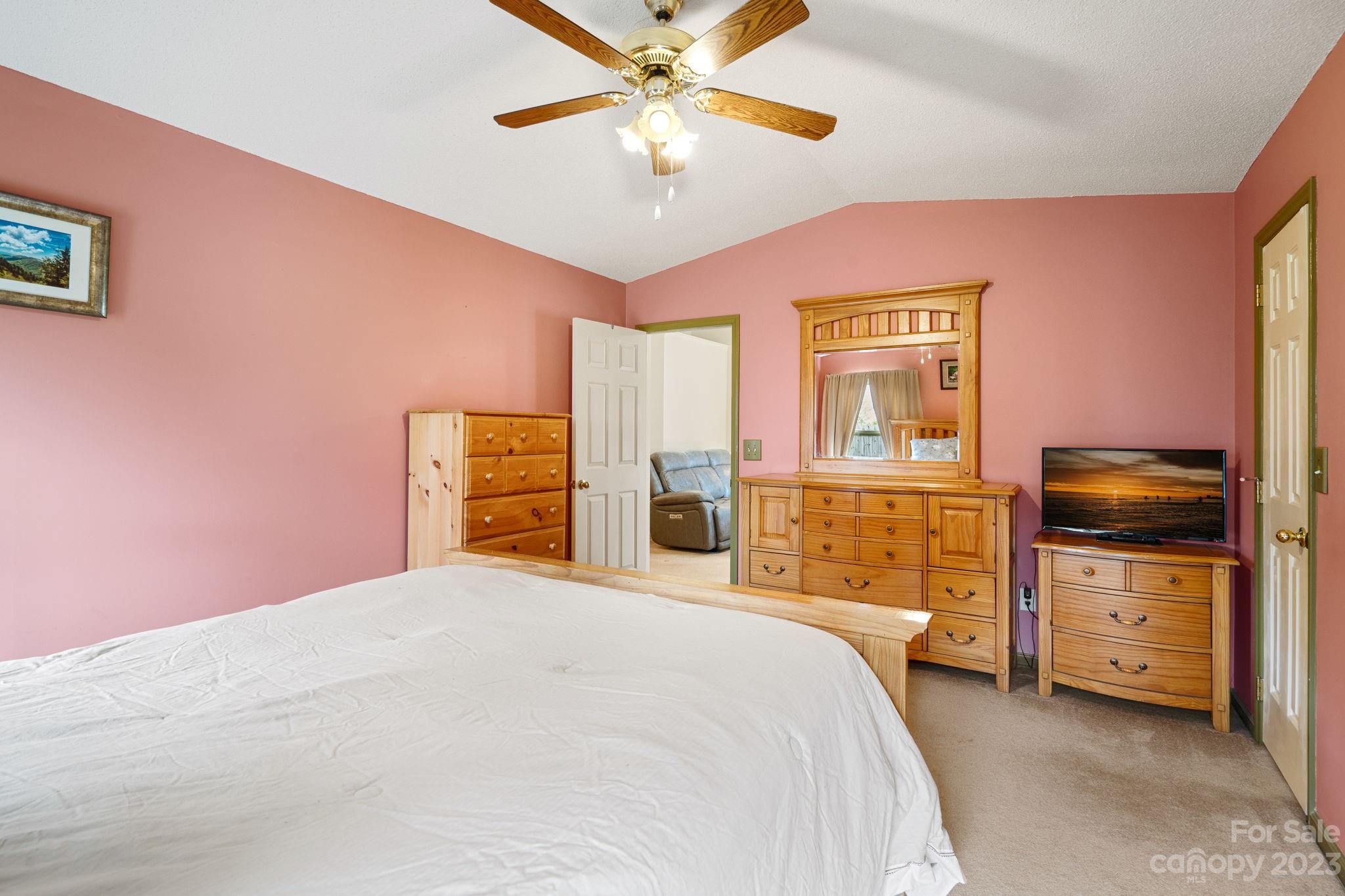 3691 Slanting Bridge Road Sherrills Ford, NC 28673 - Photo 13 of 33 a bedroom with a bed dresser and a flat tv screen