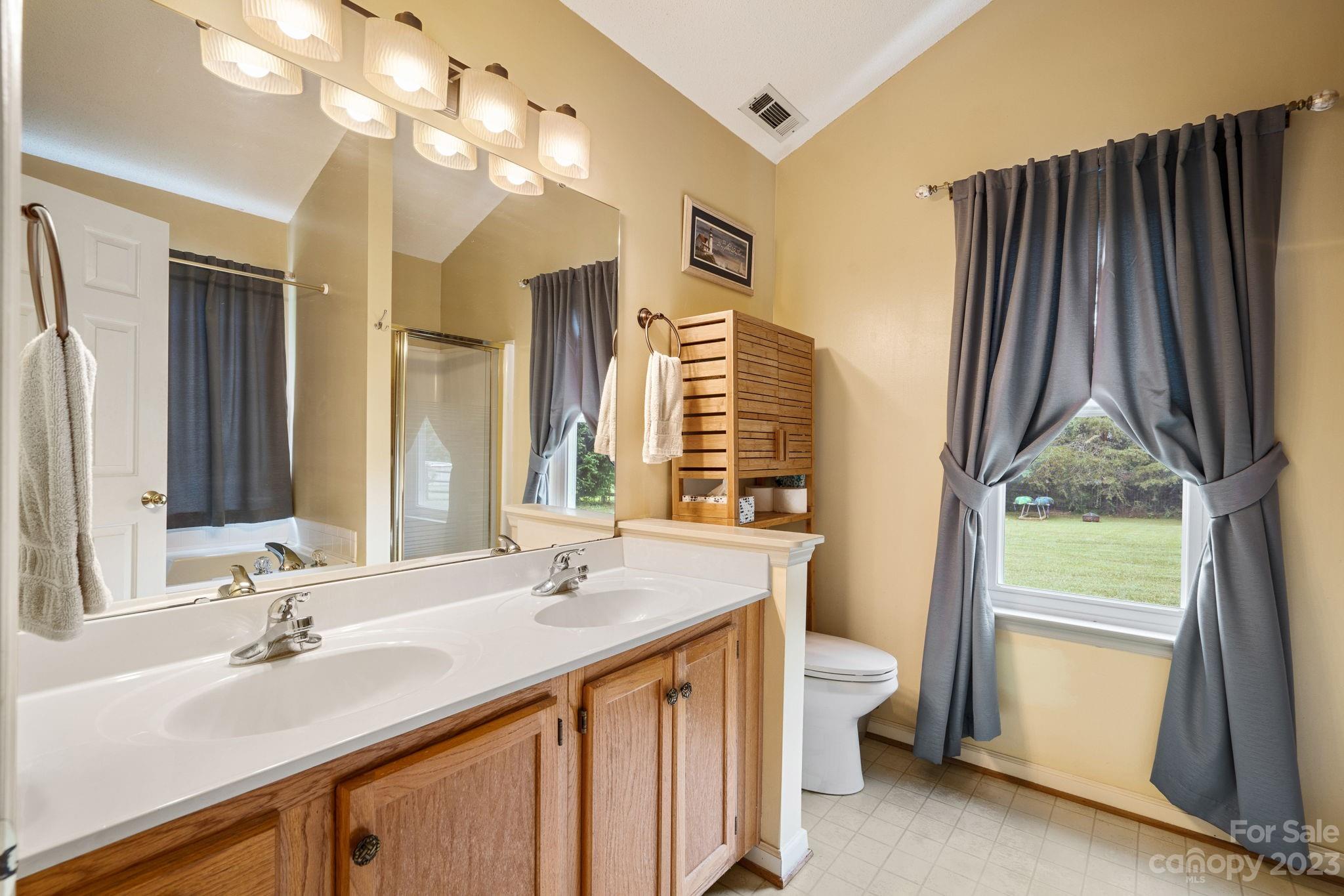 3691 Slanting Bridge Road Sherrills Ford, NC 28673 - Photo 14 of 33 a bathroom with a double vanity sink mirror and toilet