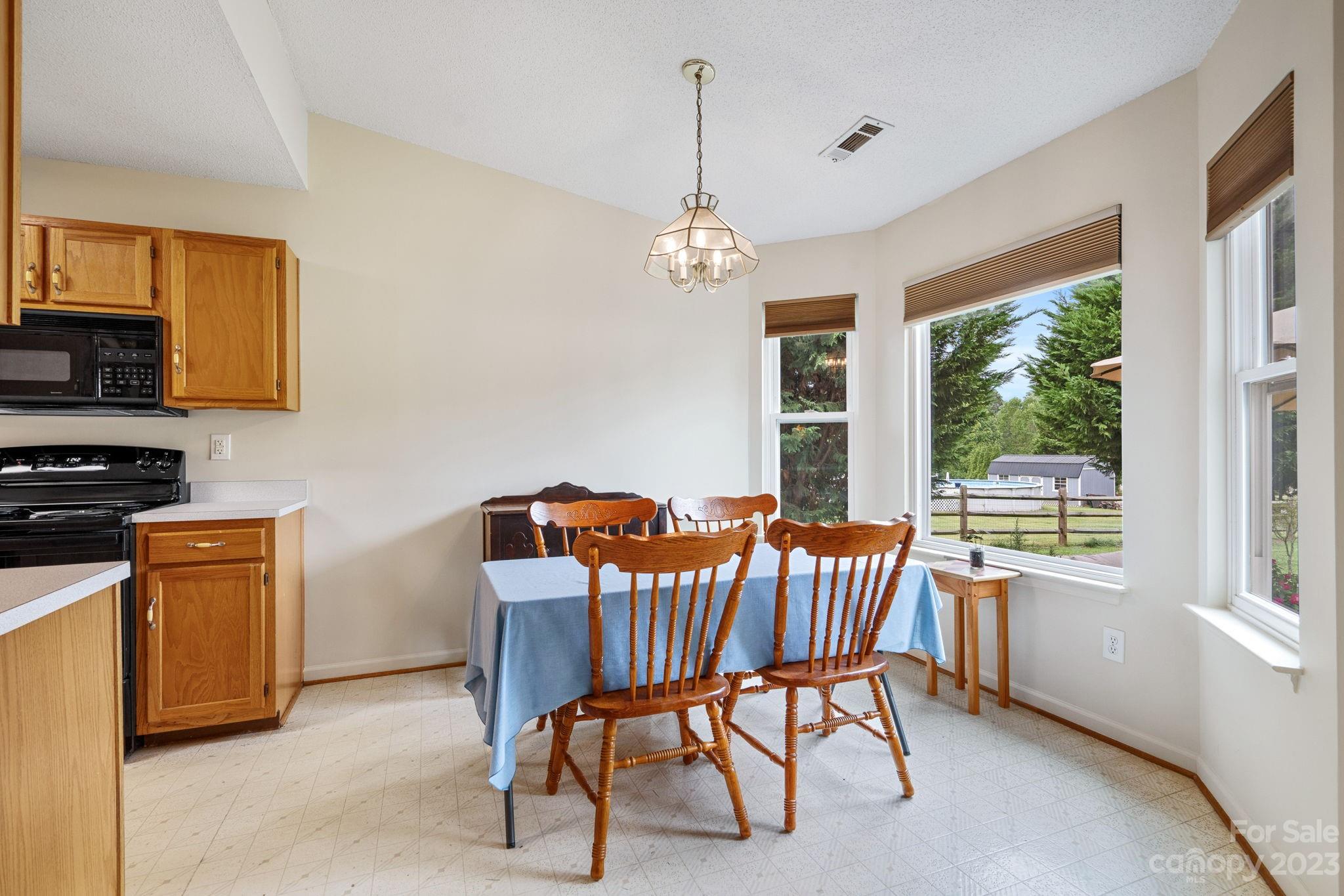 3691 Slanting Bridge Road Sherrills Ford, NC 28673 - Photo 8 of 33 a dining room with furniture a chandelier and window