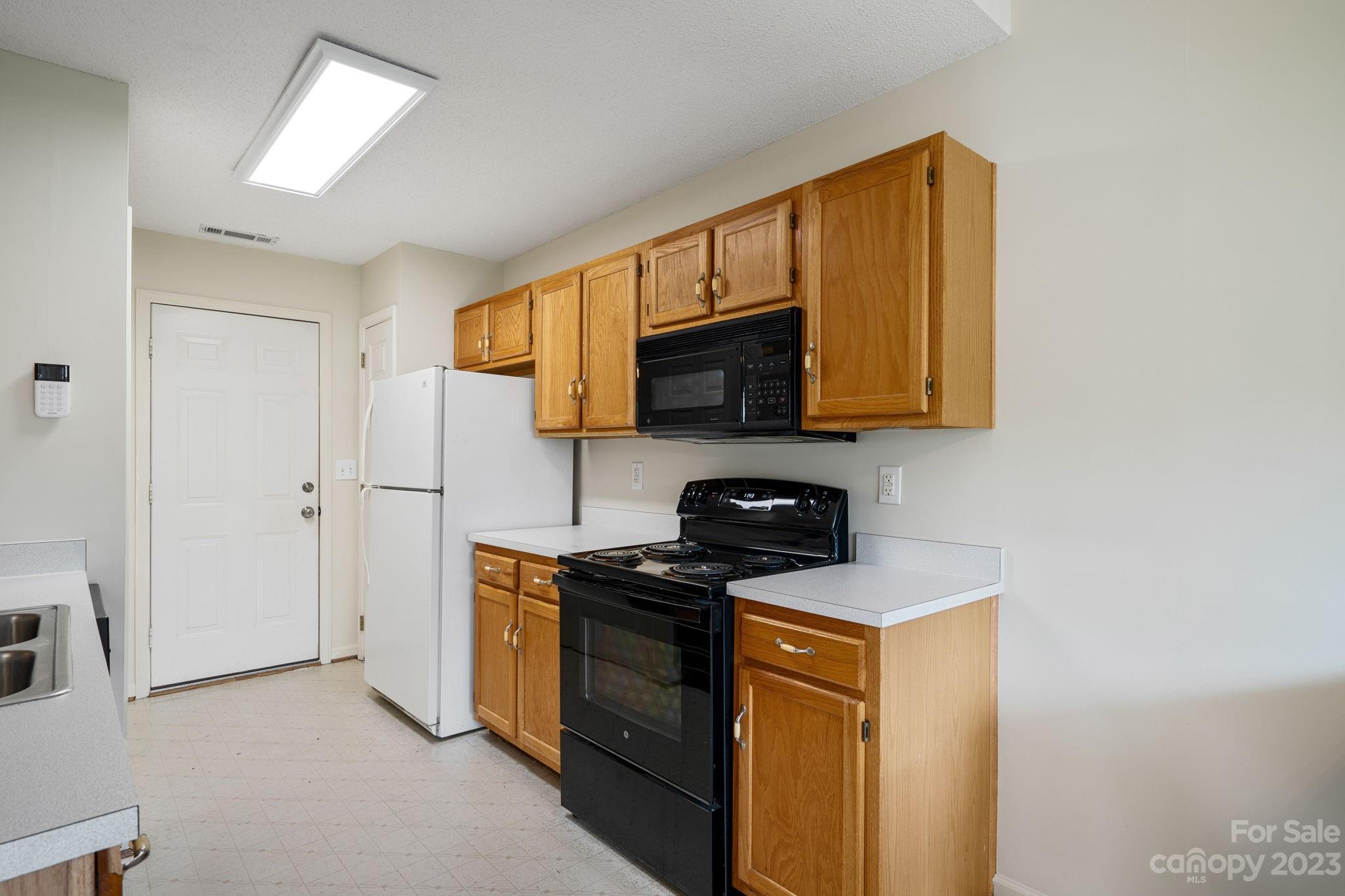 3691 Slanting Bridge Road Sherrills Ford, NC 28673 - Photo 9 of 33 a kitchen with stainless steel appliances granite countertop a stove a sink and a microwave