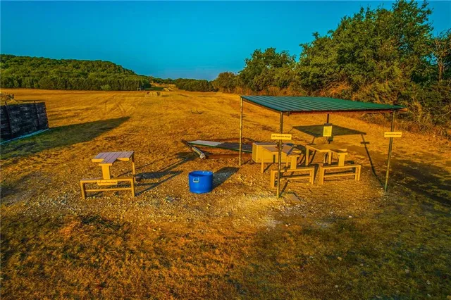 a view of a lake with a table and chairs