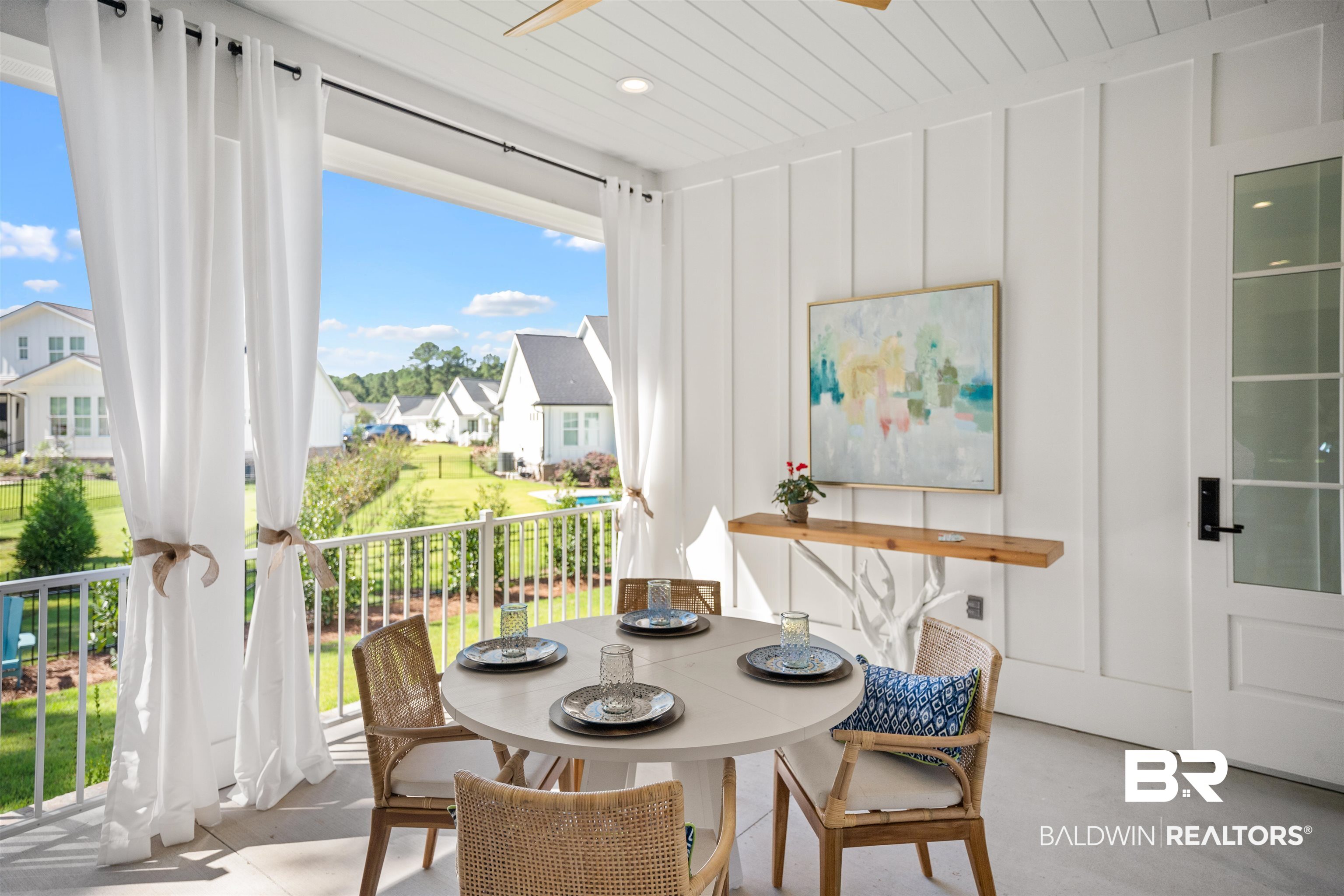 156 Hyacinth Street Fairhope, AL 36532 - Photo 27 of 61 Dining space featuring a residential view, a ceiling fan, a decorative wall, and light carpet