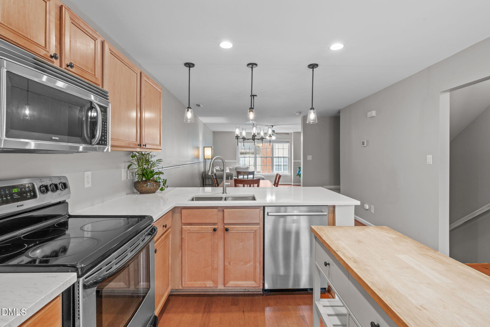 9909 Grettle Court Raleigh, NC 27617 - Photo 10 of 23 a kitchen with a sink stove and cabinets