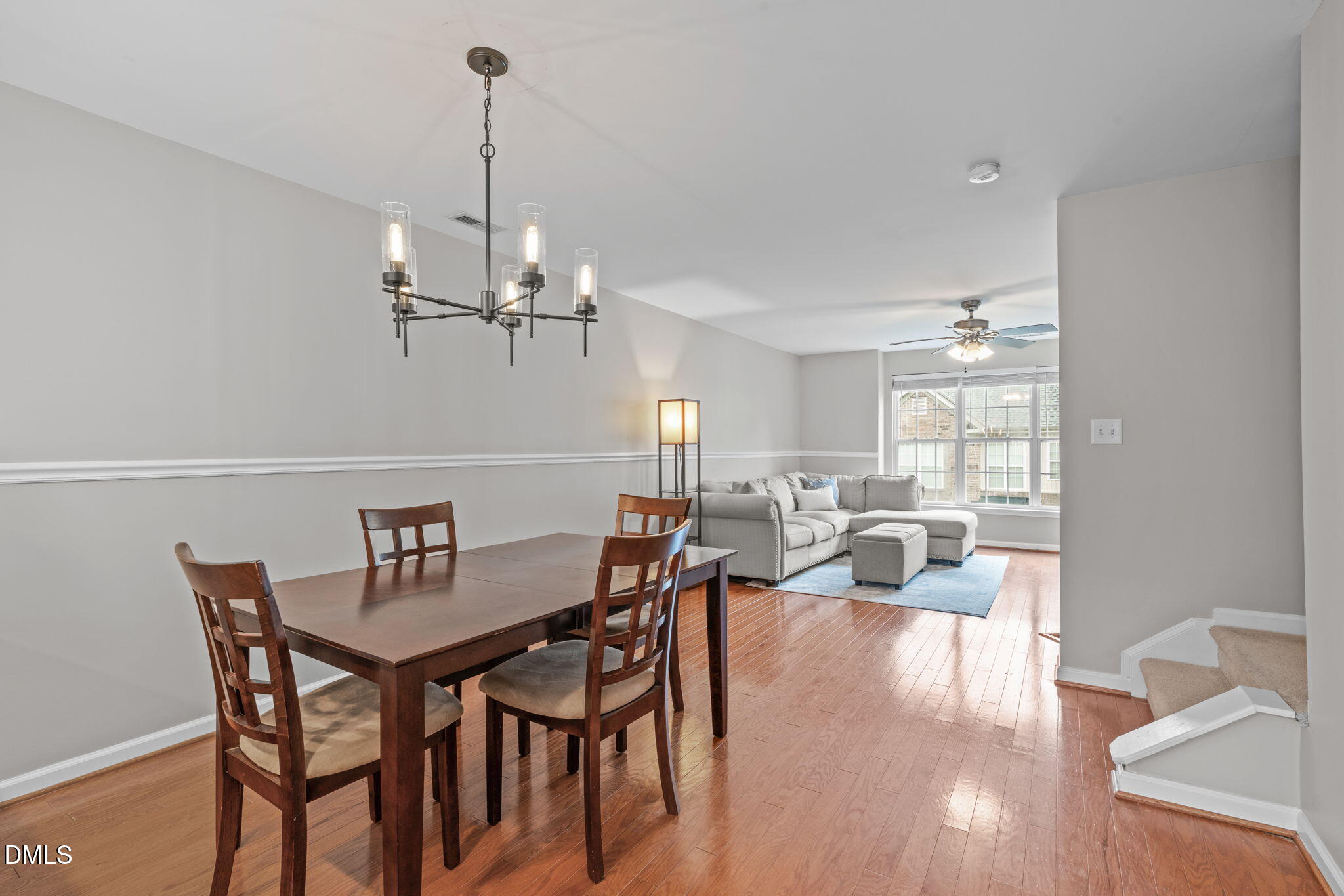 9909 Grettle Court Raleigh, NC 27617 - Photo 11 of 23 a view of a dining room with furniture wooden floor and chandelier