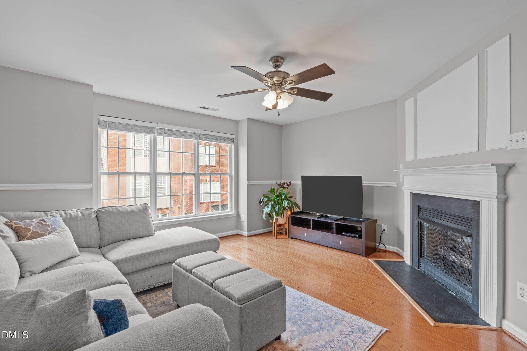 9909 Grettle Court Raleigh, NC 27617 - Photo 12 of 23 a living room with furniture a fireplace and a flat screen tv