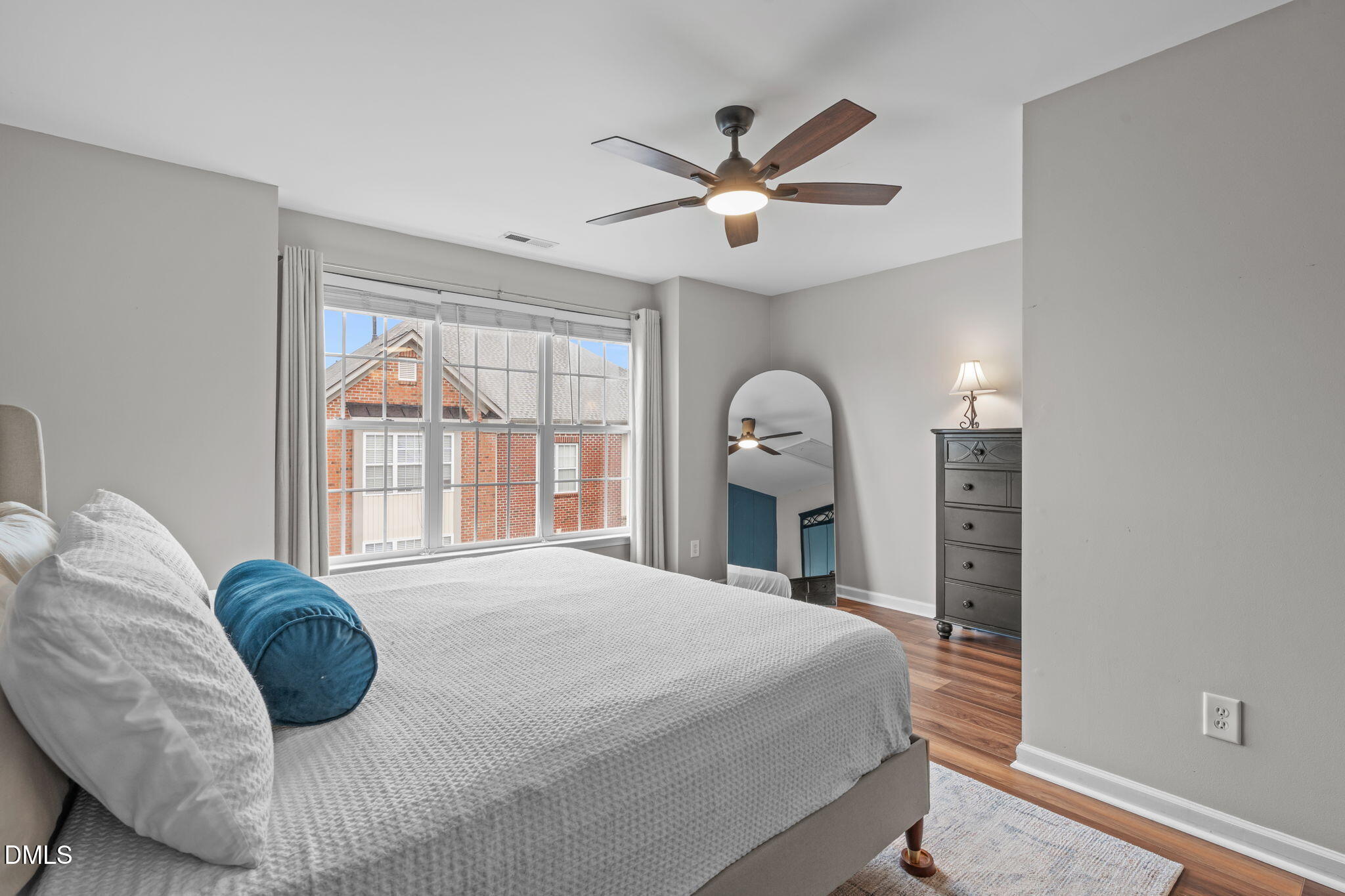 9909 Grettle Court Raleigh, NC 27617 - Photo 14 of 23 a bedroom with a large bed and a chandelier
