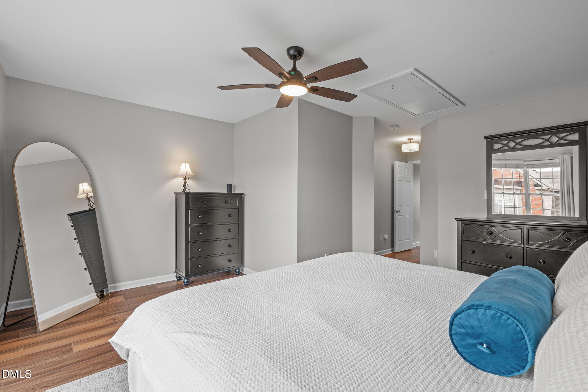 9909 Grettle Court Raleigh, NC 27617 - Photo 15 of 23 a bedroom with a bed and a chandelier