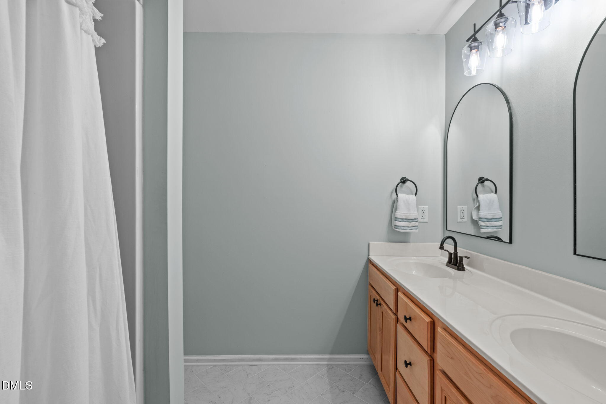 9909 Grettle Court Raleigh, NC 27617 - Photo 16 of 23 a bathroom with 2 sink and a mirror