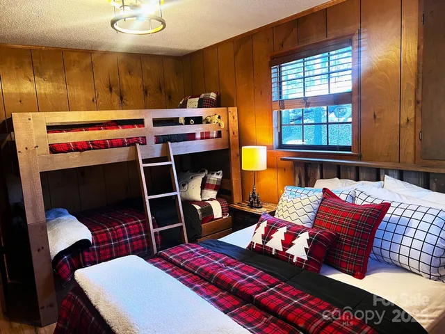 a bedroom with a bed and a potted plant