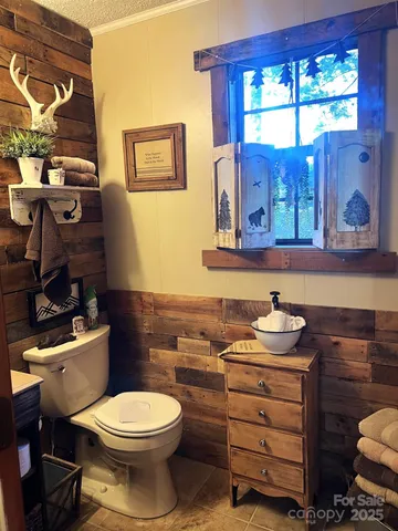 a bathroom with a sink toilet and mirror