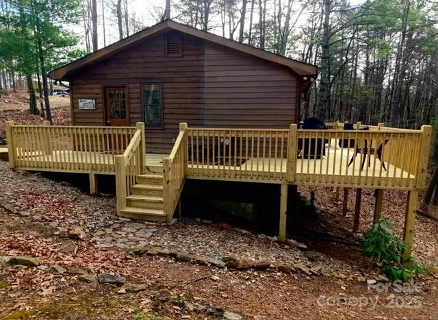 a view of a roof deck with wooden floor and fence