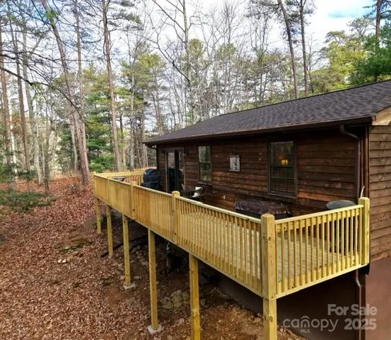 a view of house with a yard and wooden fence