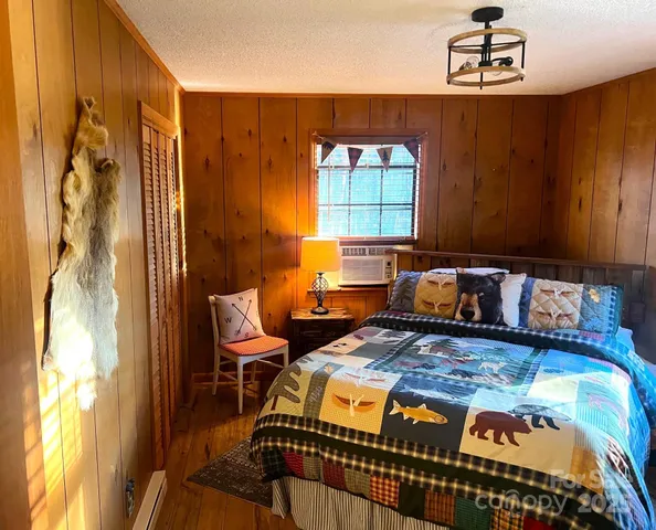 a bedroom with a bed dresser and a window