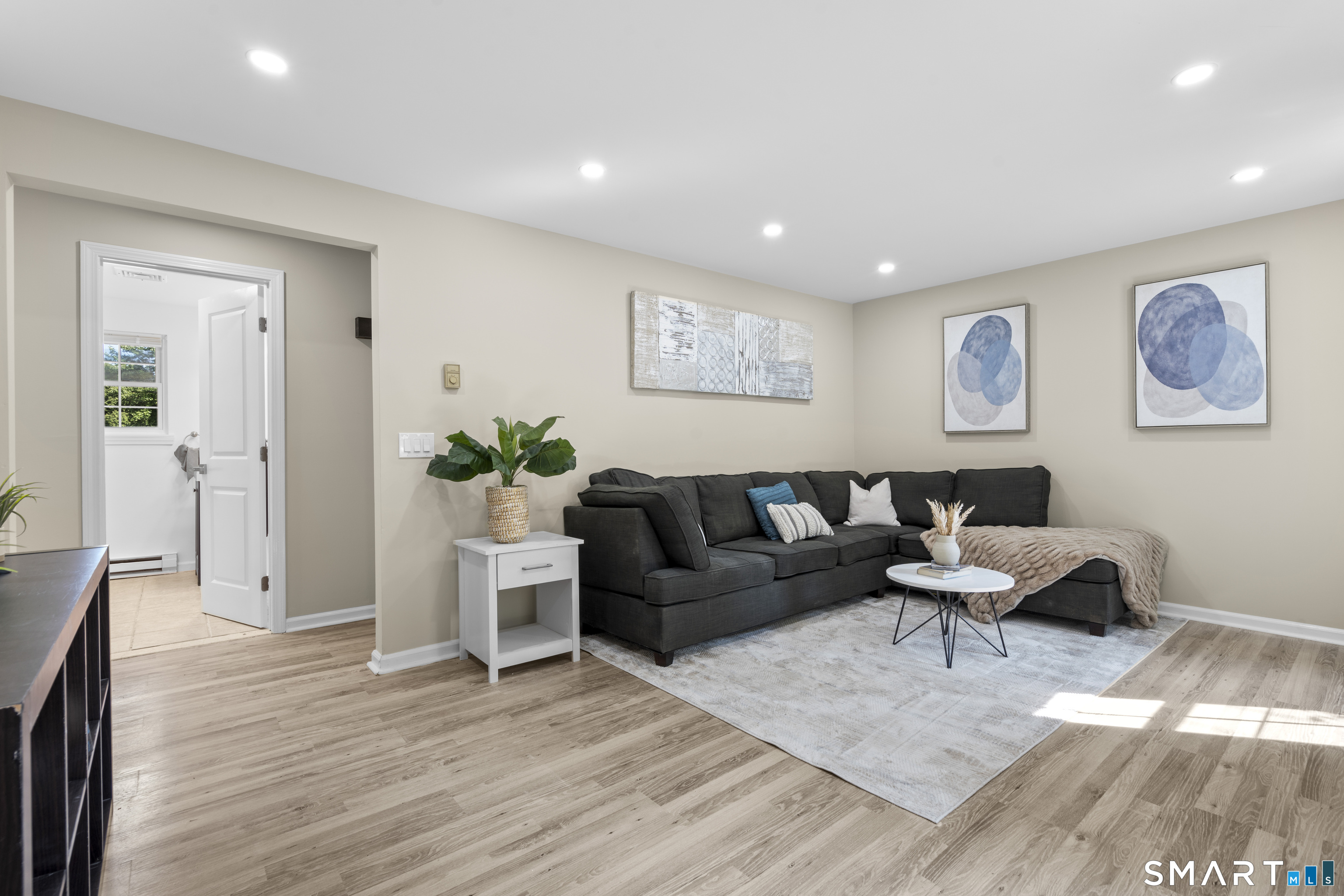 a living room with furniture and wooden floor