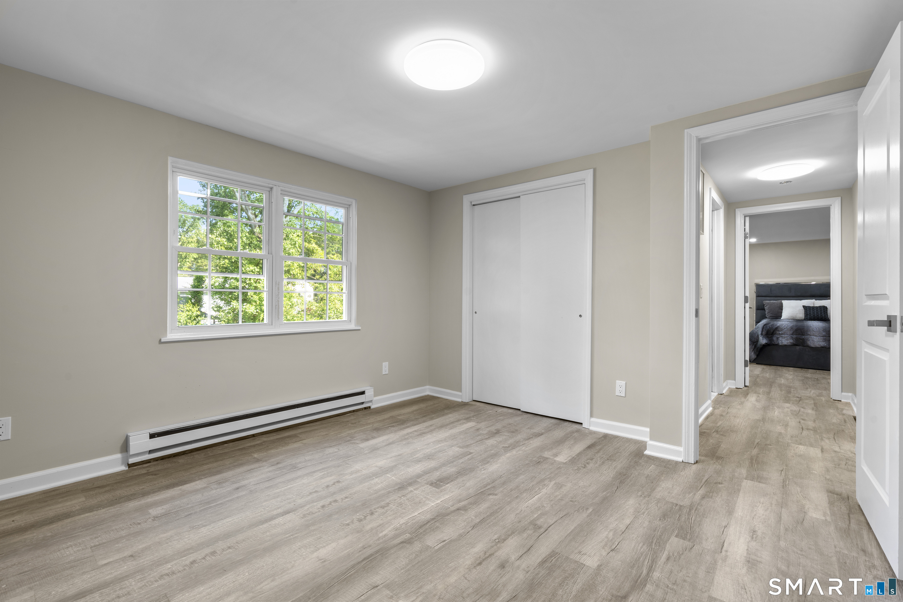 13 Williams Court Wolcott, CT 06716 - Photo 18 of 33 an empty room with wooden floor and windows