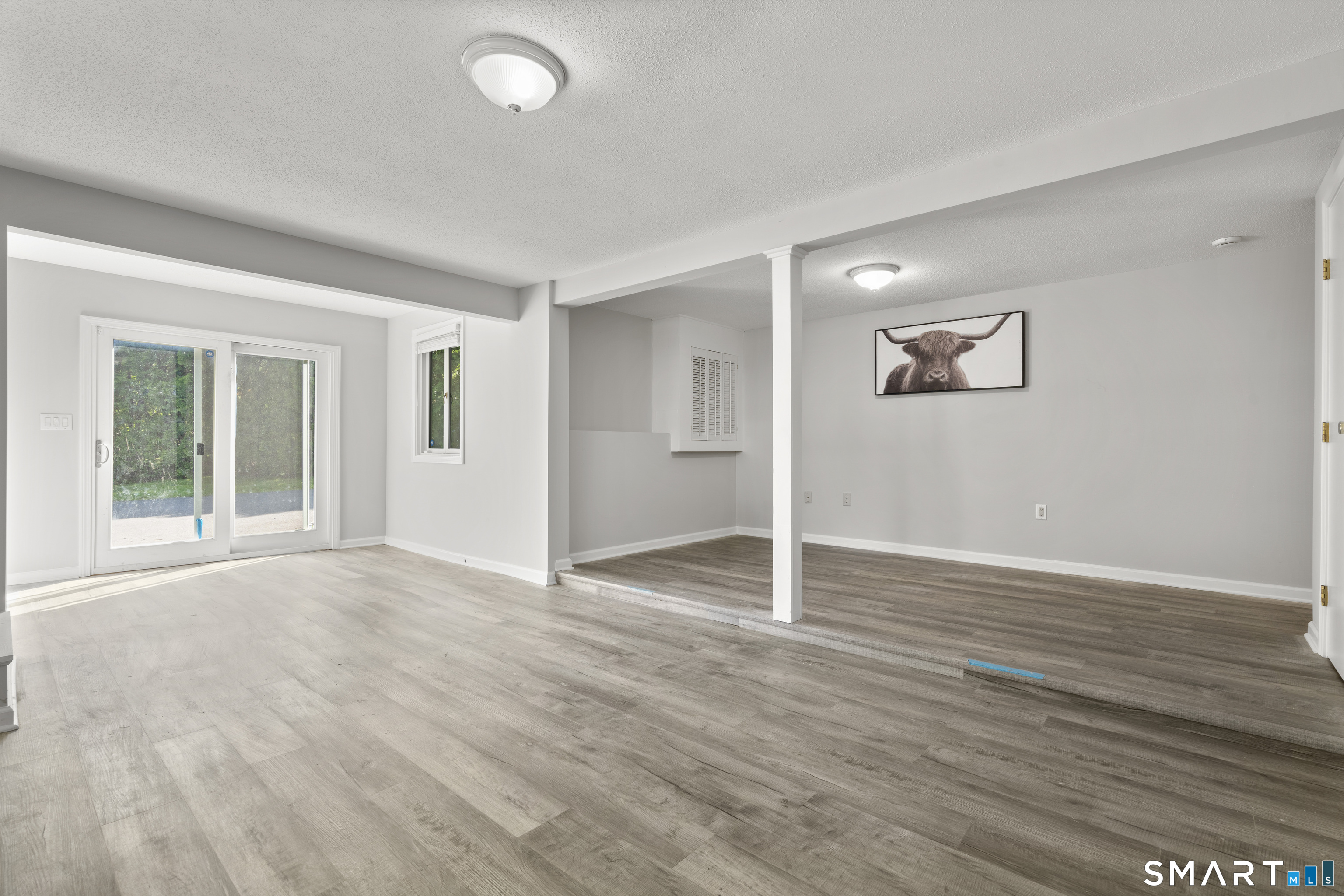 13 Williams Court Wolcott, CT 06716 - Photo 21 of 33 a view of an empty room with wooden floor and a window