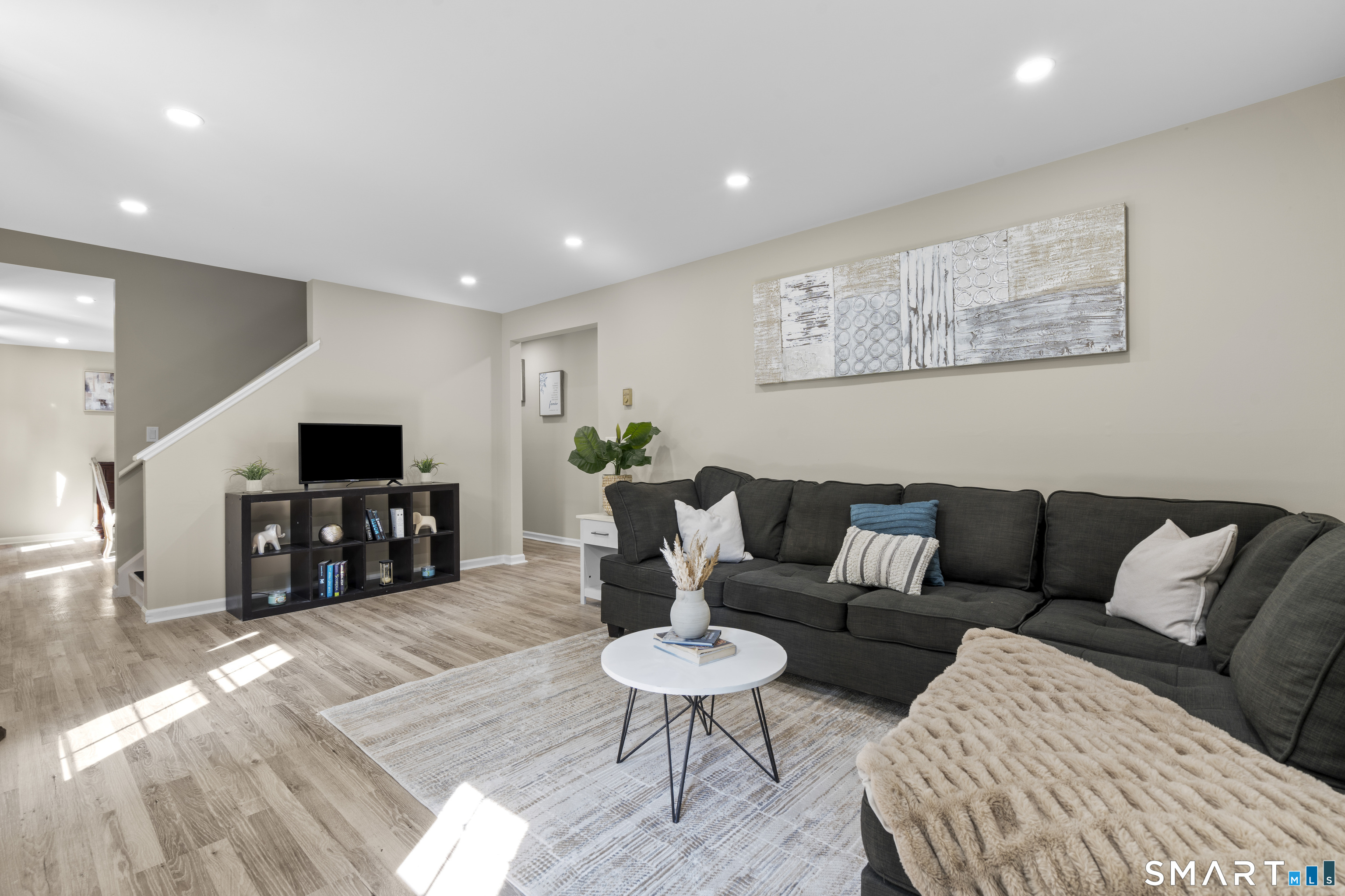 13 Williams Court Wolcott, CT 06716 - Photo 5 of 33 a living room with furniture and a flat screen tv with wooden floor