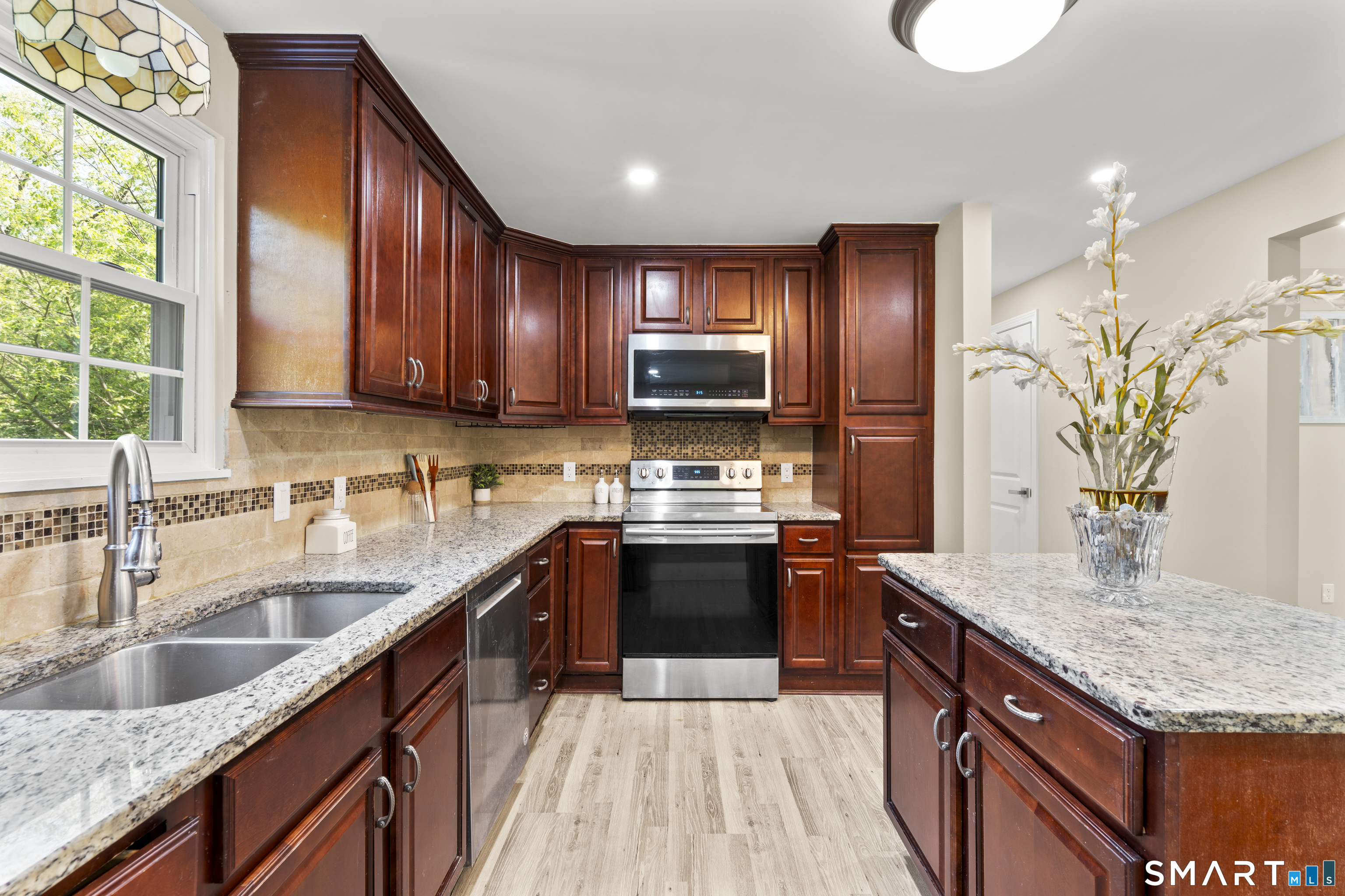 13 Williams Court Wolcott, CT 06716 - Photo 7 of 33 a kitchen with stainless steel appliances granite countertop a sink dishwasher stove and refrigerator