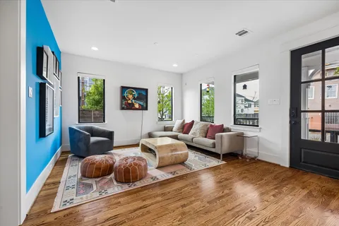 a bedroom with furniture and a wooden floor