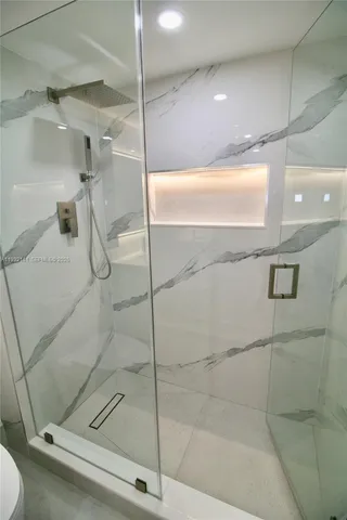a bathroom with a toilet sink and shower