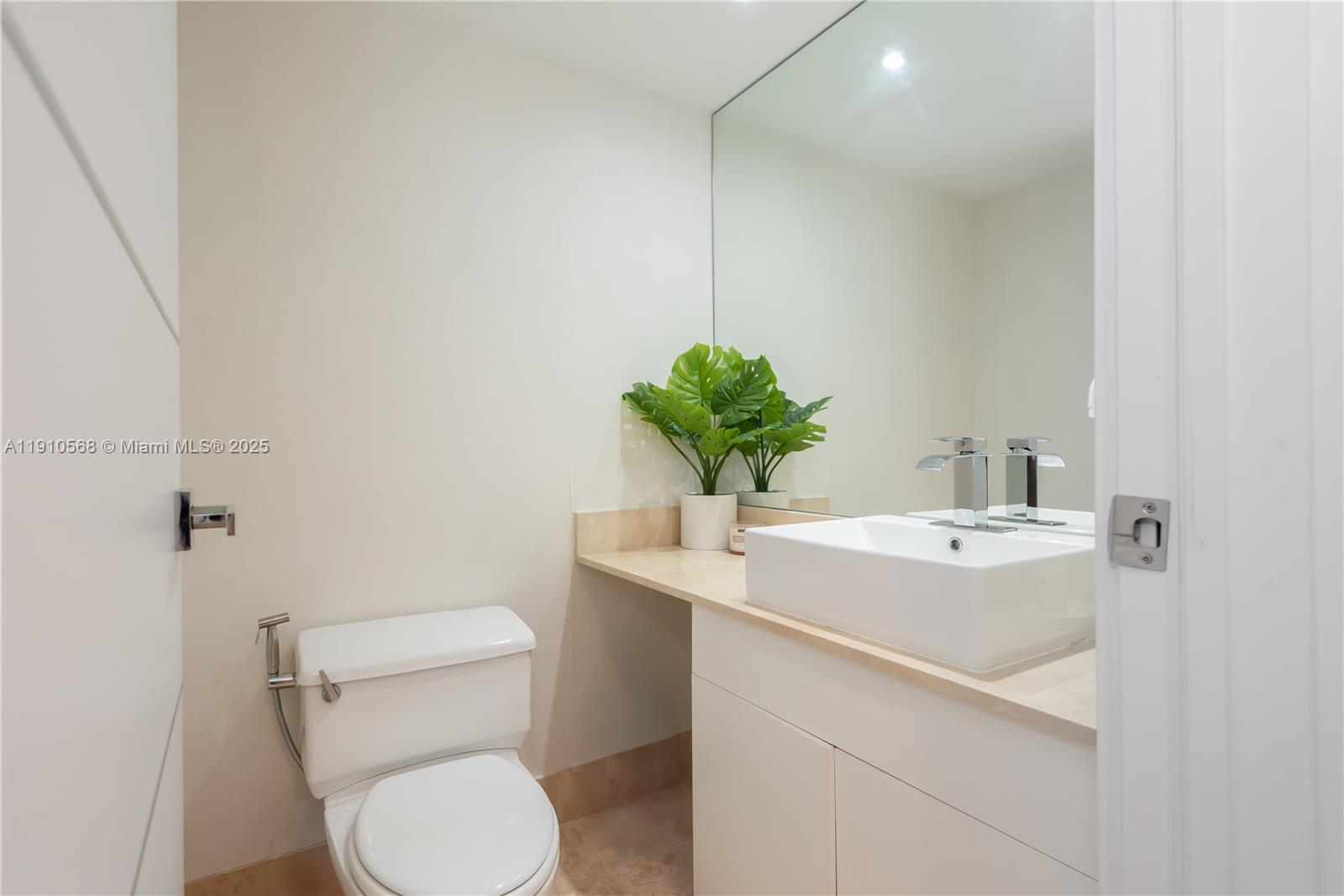 701 Brickell Key Boulevard, Unit 1912 Miami, FL 33131 - Photo 14 of 67 a bathroom with a toilet sink and mirror
