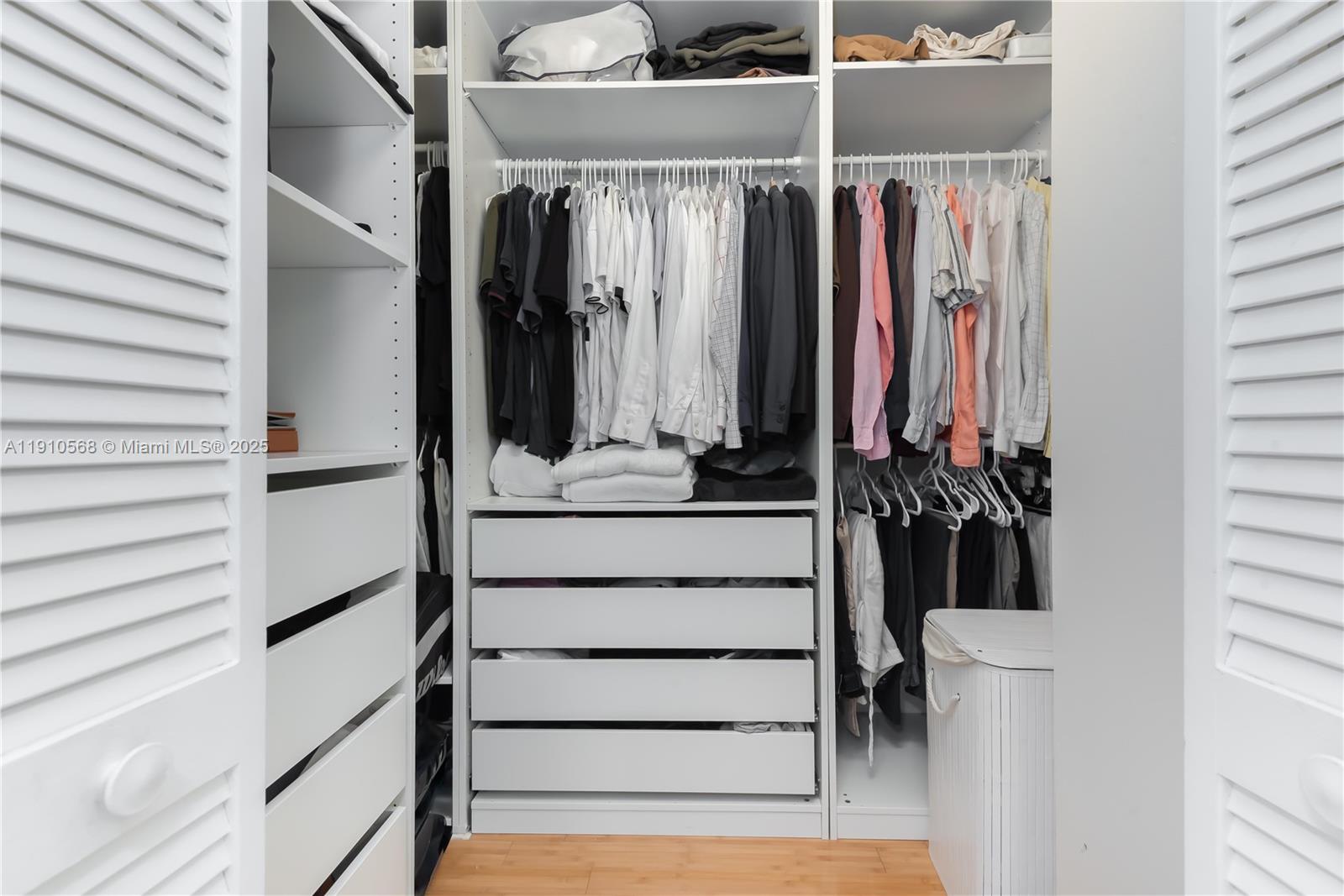 701 Brickell Key Boulevard, Unit 1912 Miami, FL 33131 - Photo 19 of 67 a view of walk in closet with clothes and shoes
