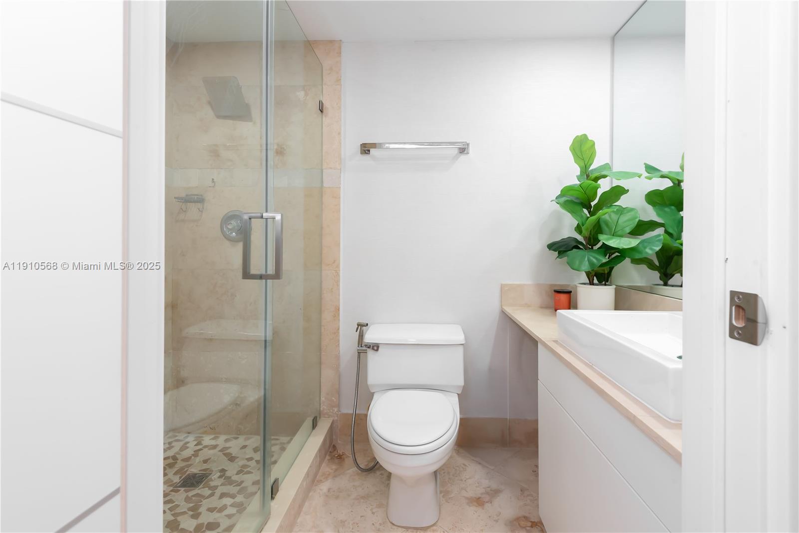 701 Brickell Key Boulevard, Unit 1912 Miami, FL 33131 - Photo 20 of 67 a white toilet sitting next to a bathroom sink