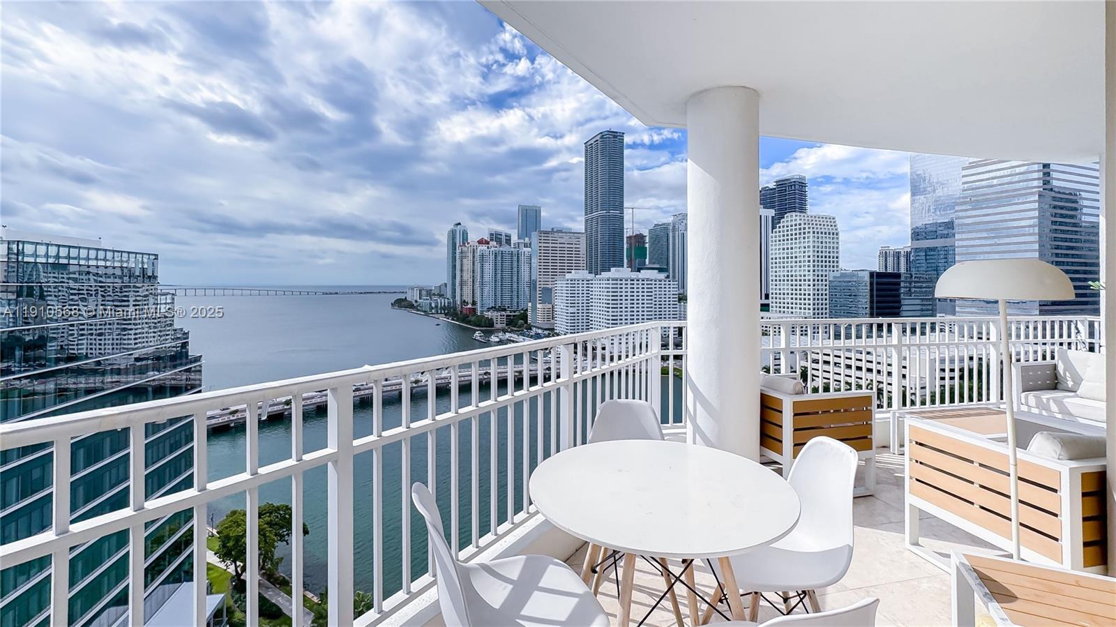 701 Brickell Key Boulevard, Unit 1912 Miami, FL 33131 - Photo 2 of 67 a view of a balcony with a table and chairs