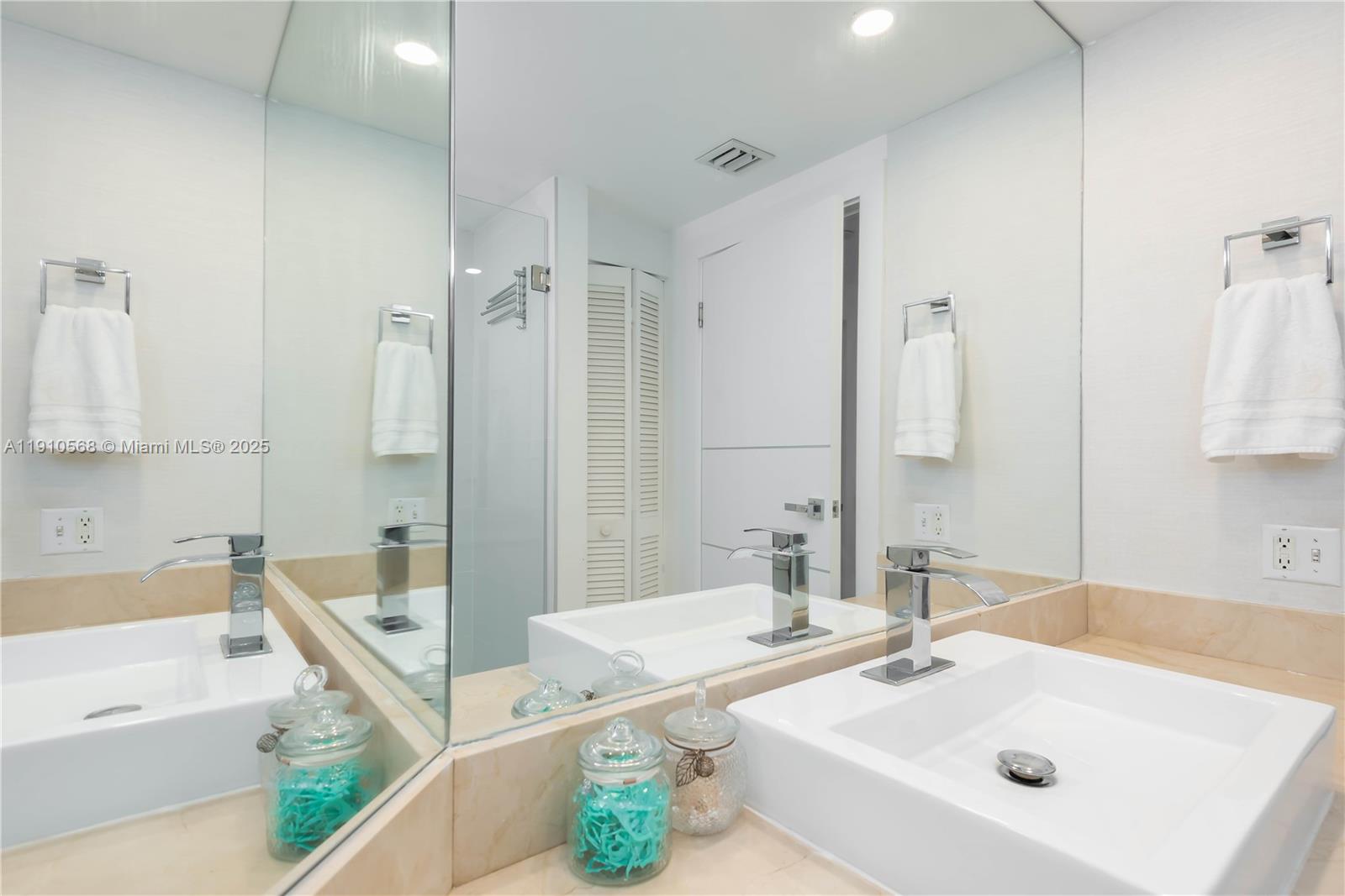 701 Brickell Key Boulevard, Unit 1912 Miami, FL 33131 - Photo 21 of 67 a bathroom with a tub sink and mirror