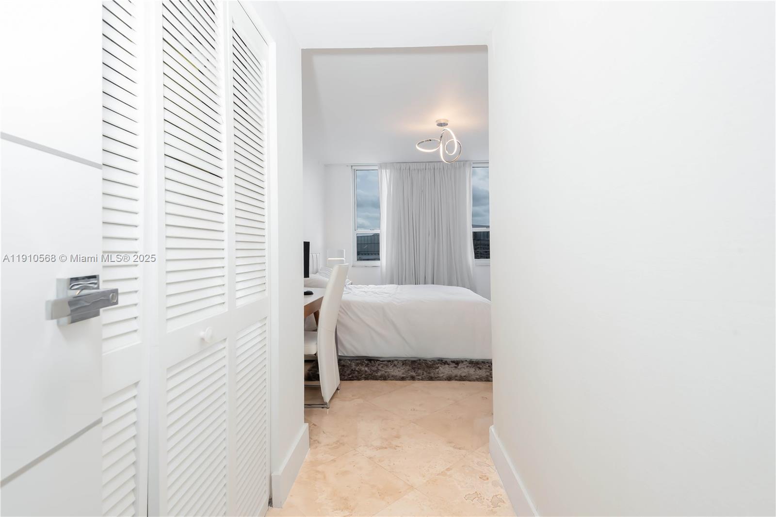 701 Brickell Key Boulevard, Unit 1912 Miami, FL 33131 - Photo 24 of 67 a spacious bedroom with a bed and a mirror