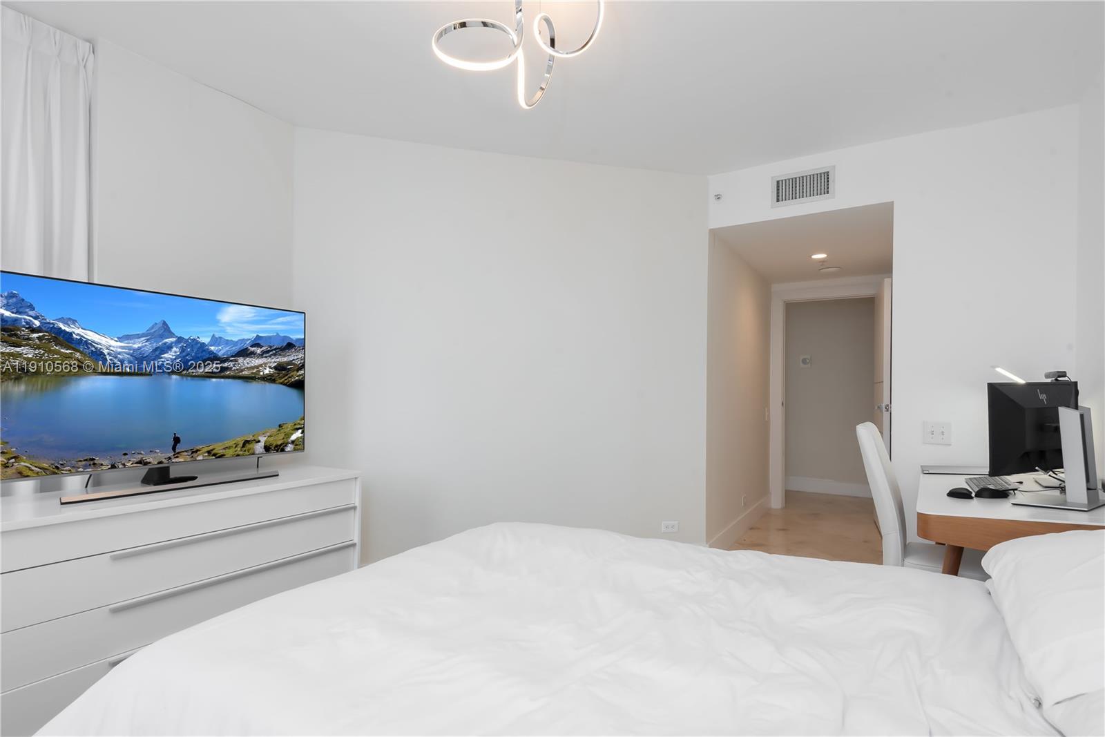 701 Brickell Key Boulevard, Unit 1912 Miami, FL 33131 - Photo 26 of 67 a bedroom with a bed and a mirror on dresser